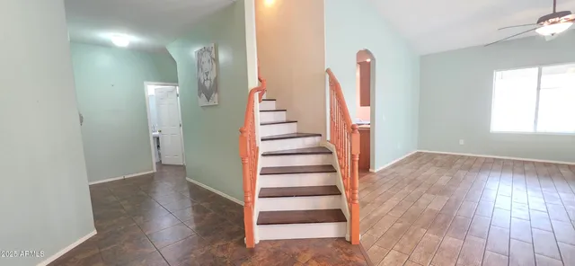 wooden floor with staircase and windows