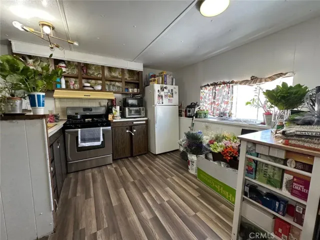 a kitchen with stainless steel appliances granite countertop a stove and a refrigerator