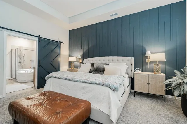 a spacious bedroom with a bed and a couch