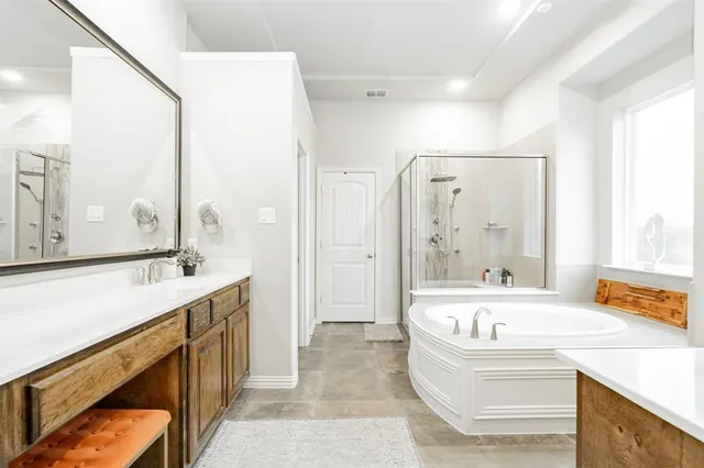 a bathroom with a tub sink and mirror