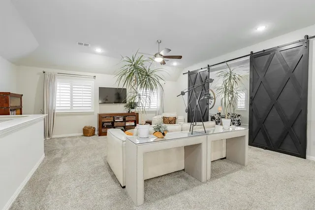 a living room with furniture and a chandelier