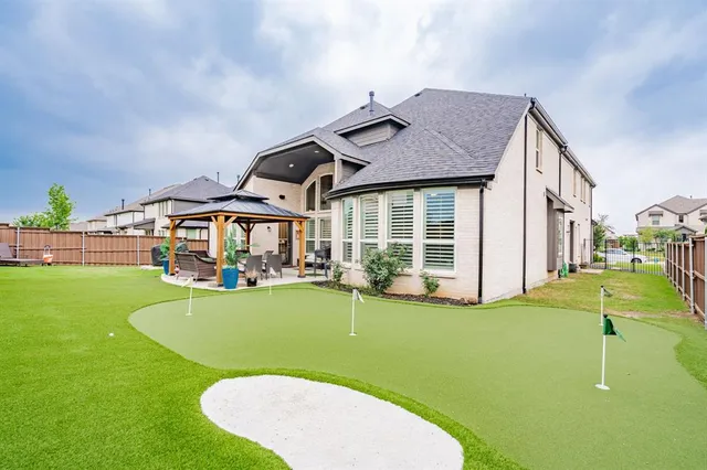 a view of a house with swimming pool and a yard