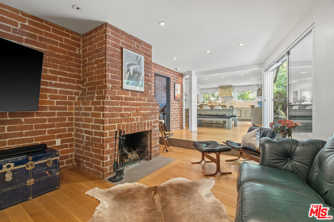 1853 Nichols Canyon Road Los Angeles, CA 90046 - Photo 15 of 48 a living room with furniture a flat screen tv and a fireplace