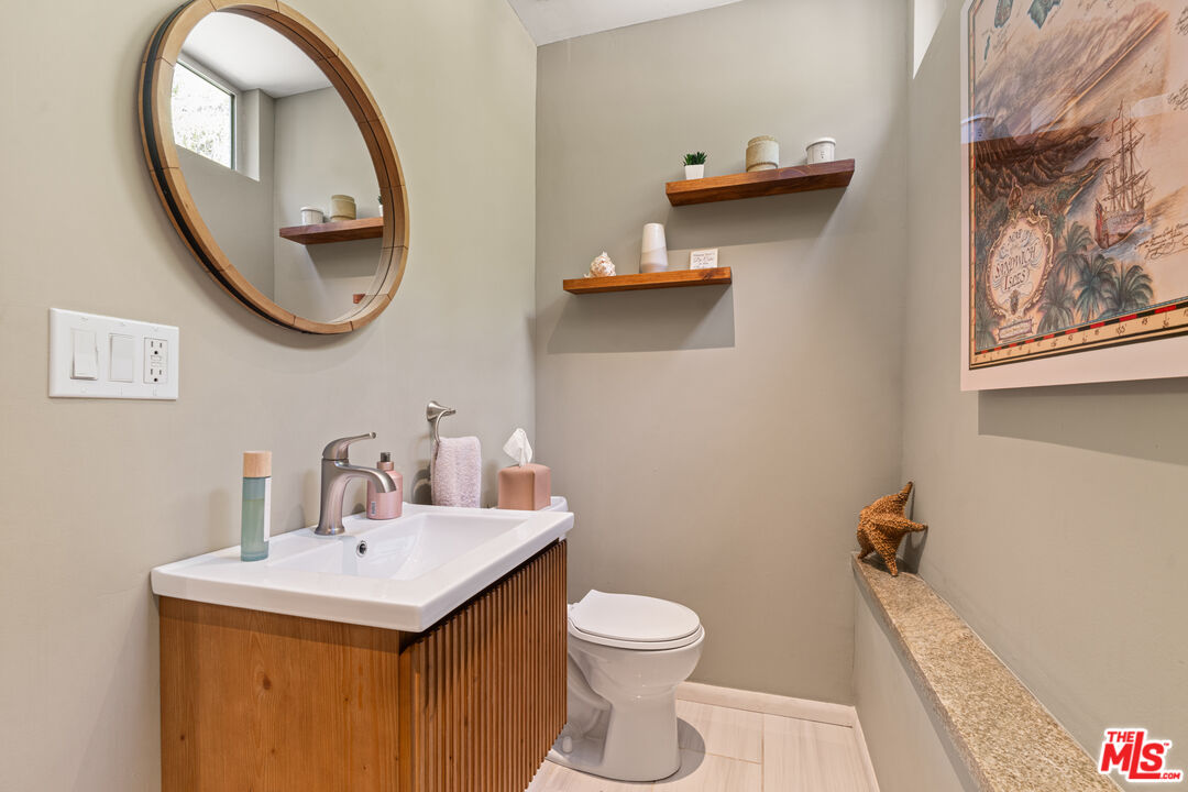 1853 Nichols Canyon Road Los Angeles, CA 90046 - Photo 16 of 48 a bathroom with a toilet sink and mirror