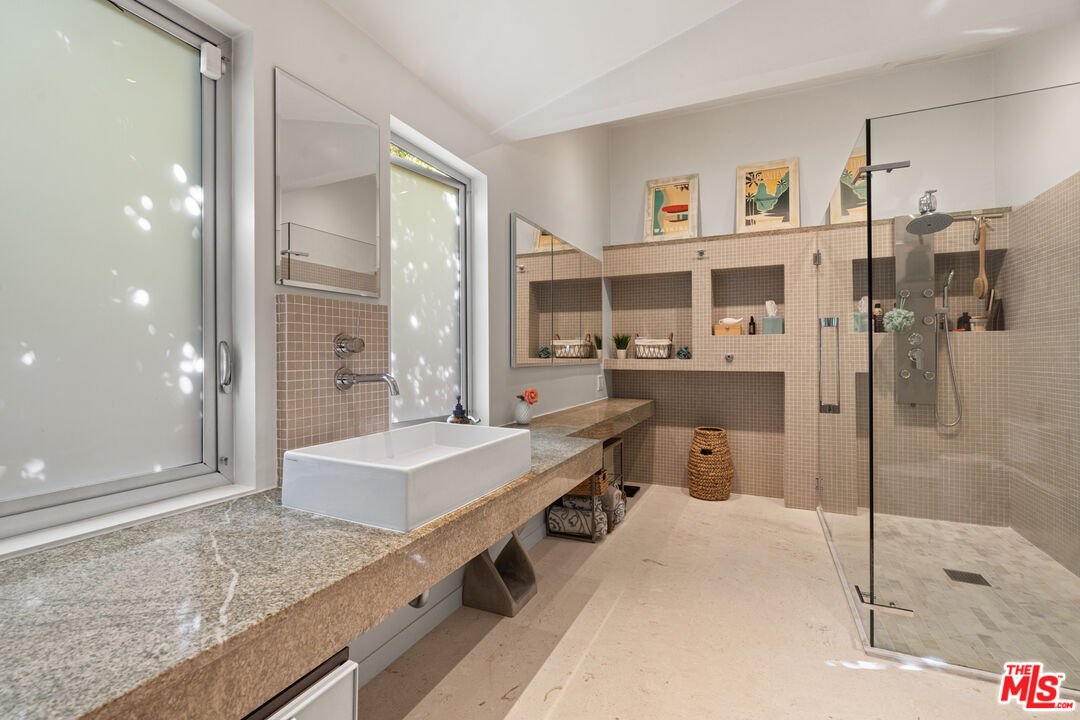 1853 Nichols Canyon Road Los Angeles, CA 90046 - Photo 20 of 48 a spacious bathroom with a granite countertop sink a mirror and a shower