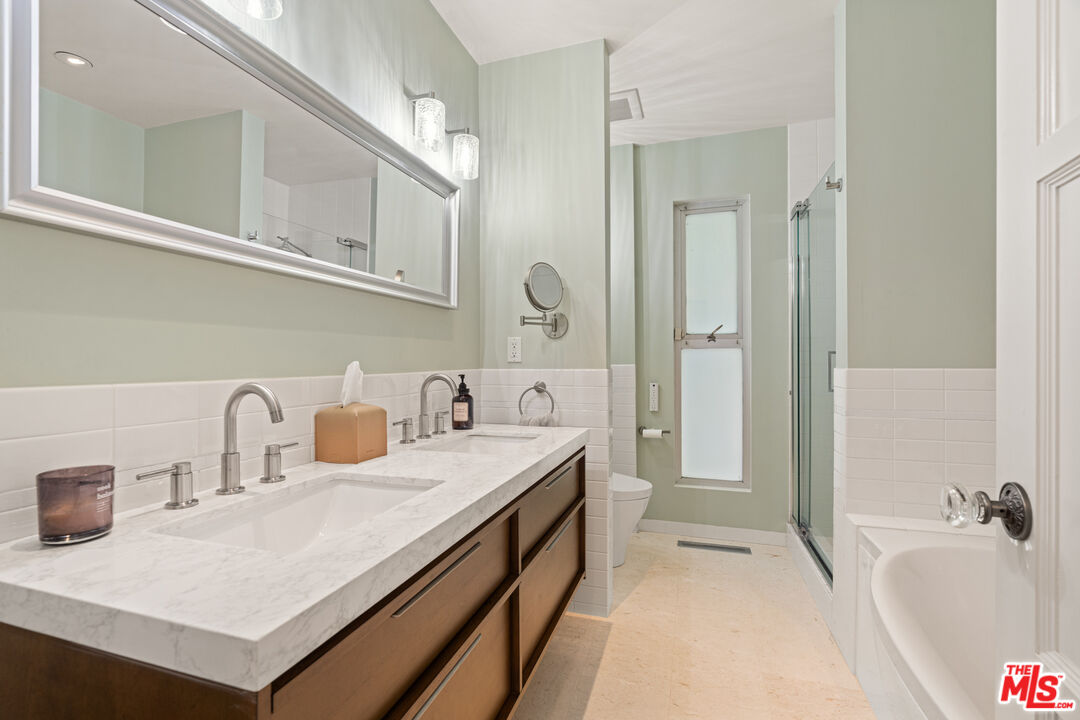 1853 Nichols Canyon Road Los Angeles, CA 90046 - Photo 23 of 48 a bathroom with a tub sink and mirror