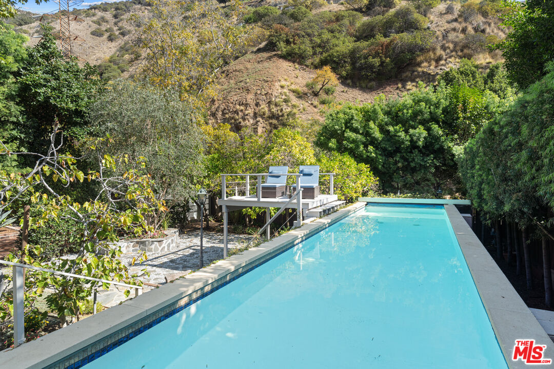 1853 Nichols Canyon Road Los Angeles, CA 90046 - Photo 30 of 48 a view of a swimming pool with an outdoor seating and a forest