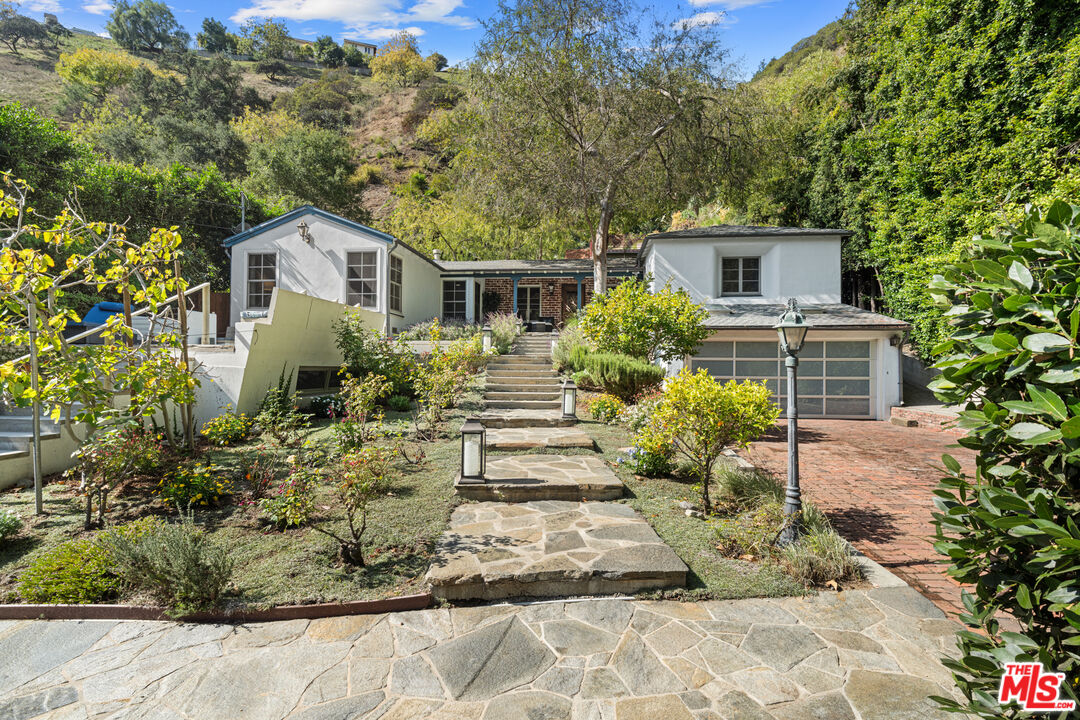 1853 Nichols Canyon Road Los Angeles, CA 90046 - Photo 4 of 48 a front view of a house with a yard and garage