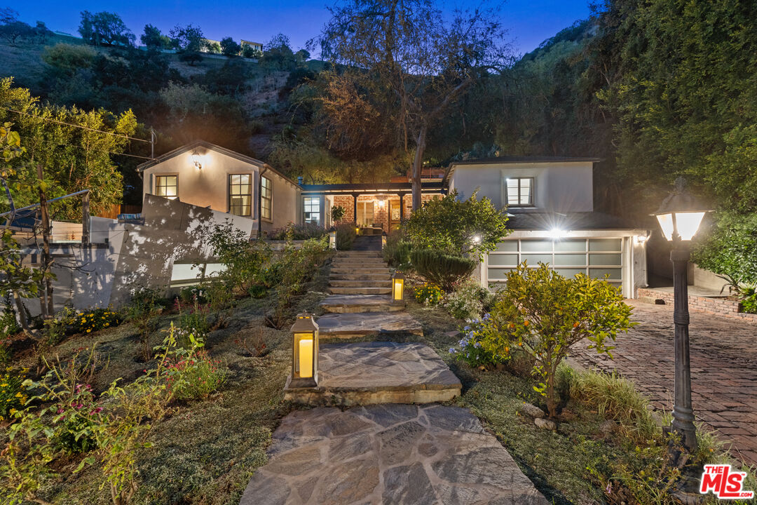 1853 Nichols Canyon Road Los Angeles, CA 90046 - Photo 45 of 48 a front view of a house with a yard