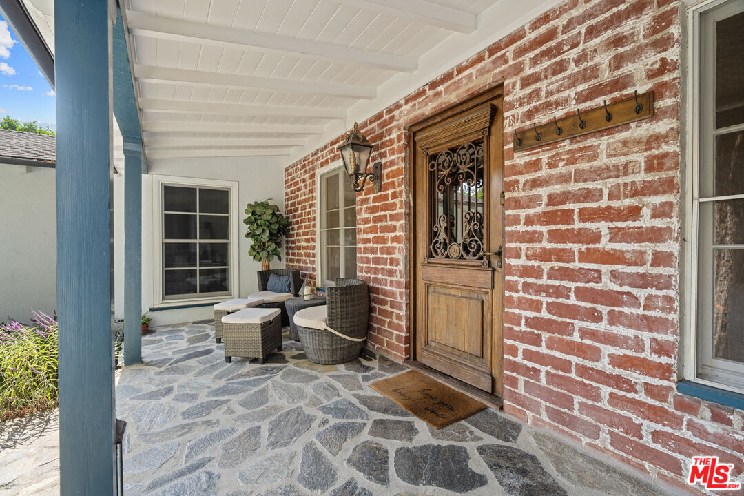 1853 Nichols Canyon Road Los Angeles, CA 90046 - Photo 6 of 48 a view of a door with a chair and potted plant