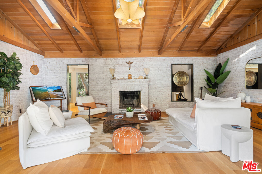 1853 Nichols Canyon Road Los Angeles, CA 90046 - Photo 7 of 48 a living room with furniture and a fireplace