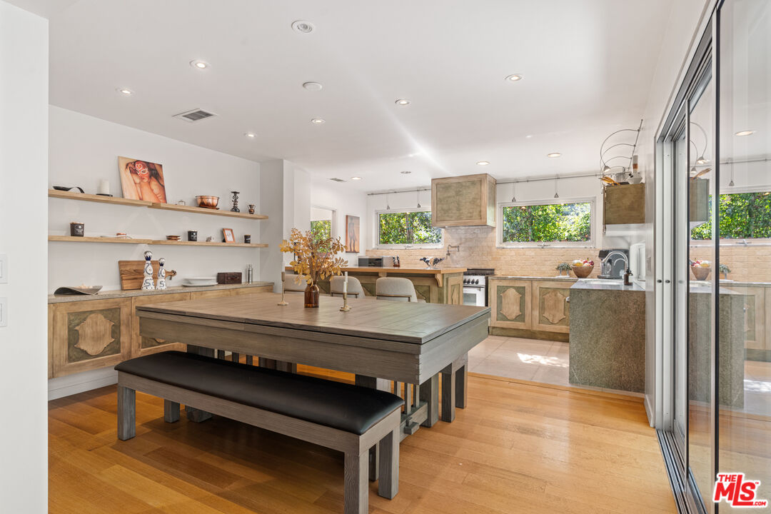 1853 Nichols Canyon Road Los Angeles, CA 90046 - Photo 10 of 48 a large living room with stainless steel appliances kitchen island granite countertop furniture and a view of living room