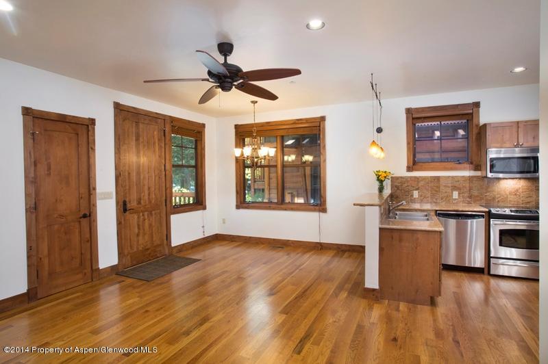 507 West Main Street, Unit C101 Aspen, CO 81611 - Photo 2 of 16 a kitchen with a wooden floor and a kitchen