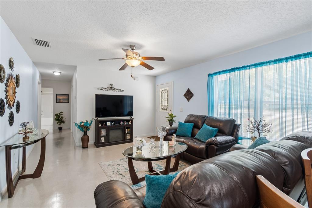 468 North Wheeler Avenue Inverness, FL 34453 - Photo 6 of 24 a living room with furniture kitchen view and a flat screen tv