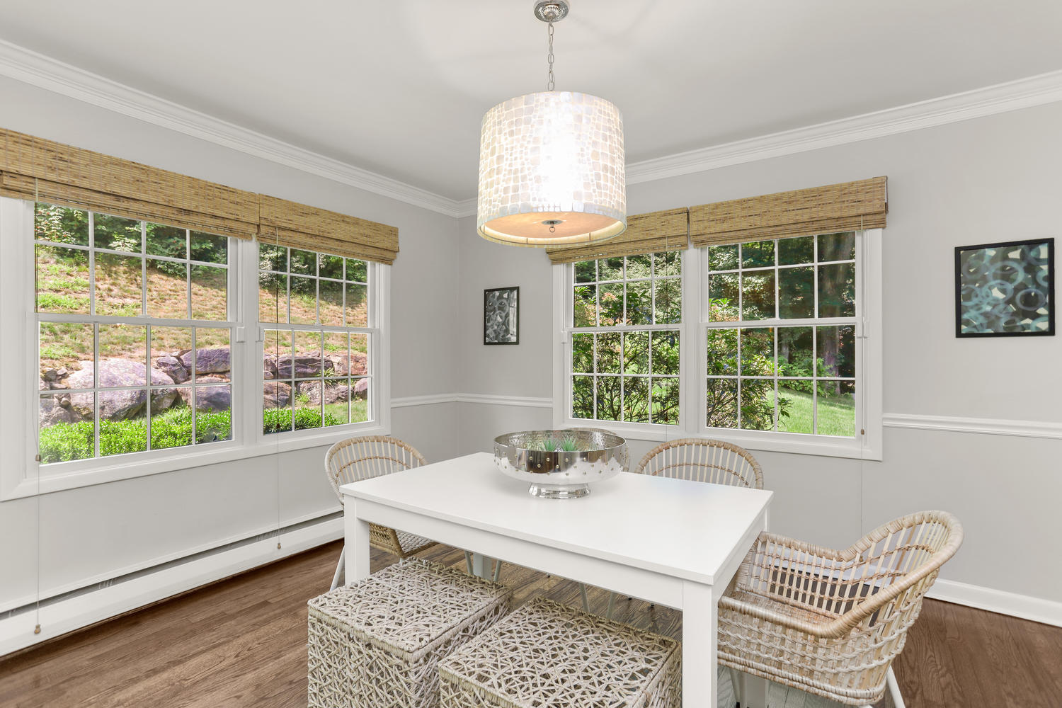 704 Valley Road New Canaan, CT 06840 - Photo 14 of 59 a dining room with wooden floor a chandelier a wooden table and chairs