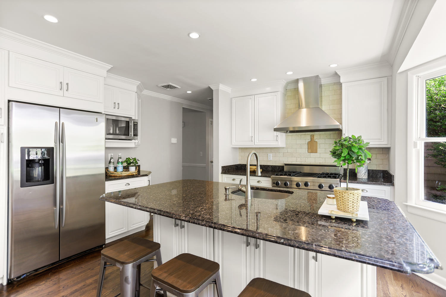704 Valley Road New Canaan, CT 06840 - Photo 16 of 59 a kitchen with stainless steel appliances granite countertop a sink a stove and a refrigerator