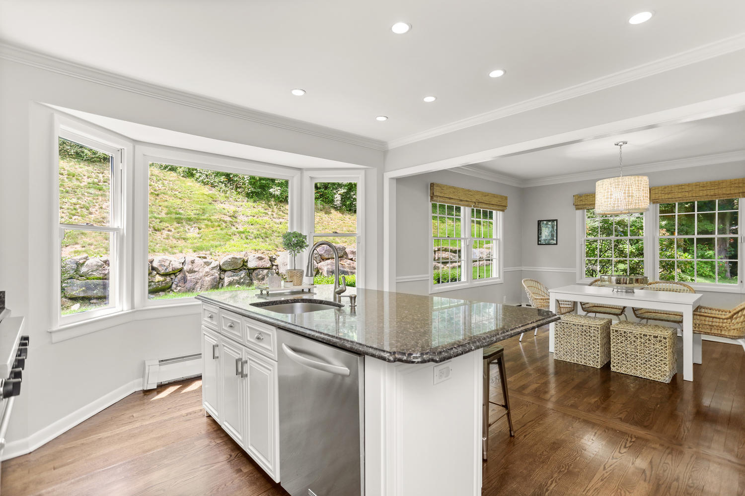 704 Valley Road New Canaan, CT 06840 - Photo 19 of 59 a kitchen with a large window and chairs