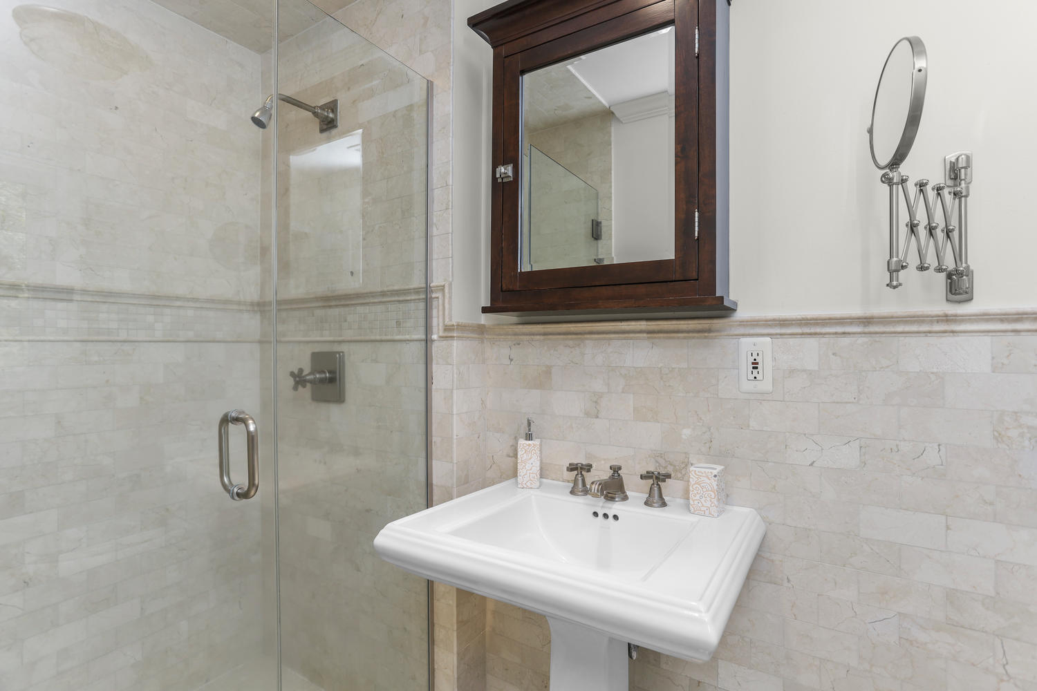 704 Valley Road New Canaan, CT 06840 - Photo 28 of 59 a bathroom with a sink a vanity and mirror