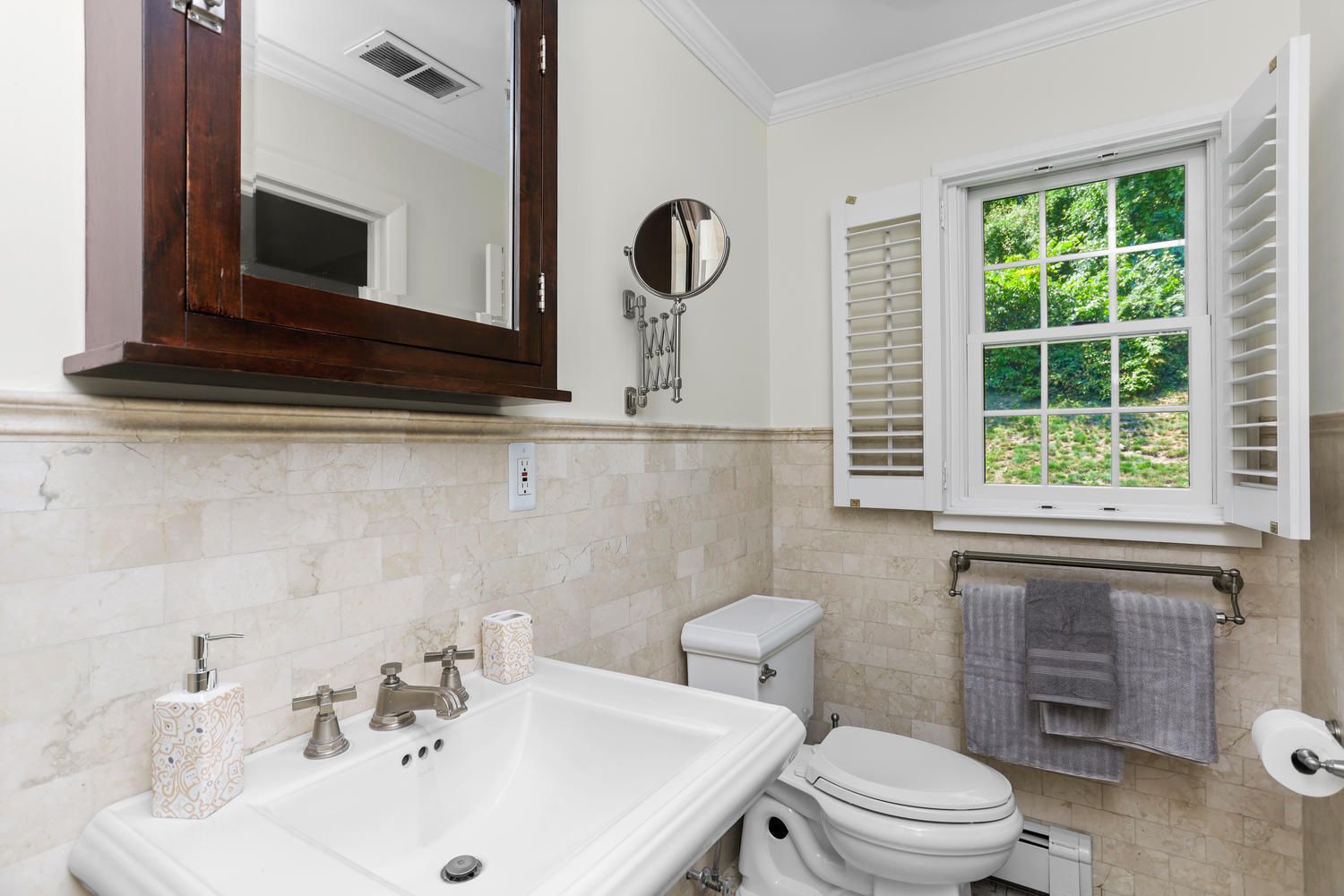 704 Valley Road New Canaan, CT 06840 - Photo 29 of 59 a bathroom with a toilet sink and mirror