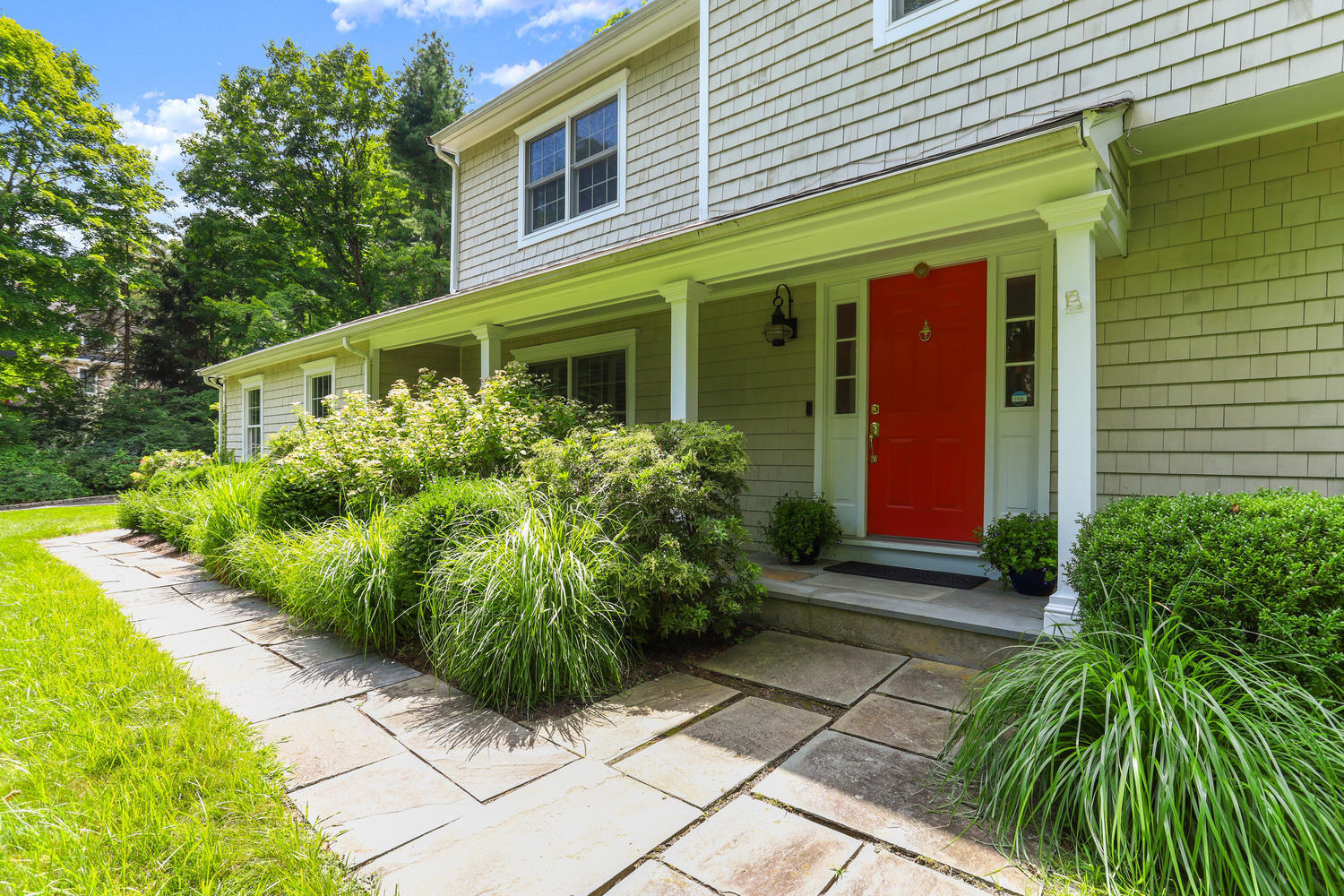 704 Valley Road New Canaan, CT 06840 - Photo 4 of 59 a front view of a house with garden