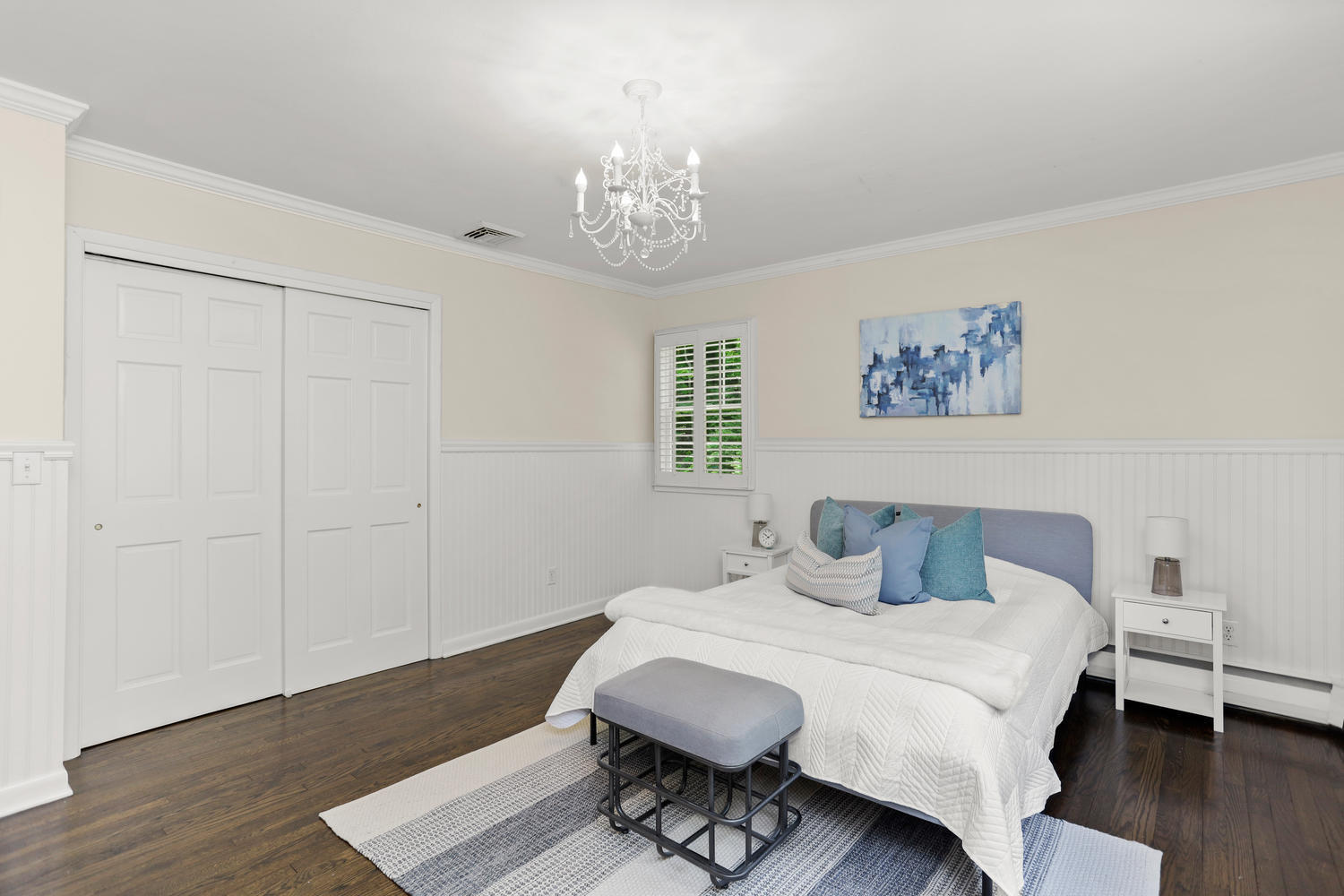704 Valley Road New Canaan, CT 06840 - Photo 31 of 59 a bedroom with a bed and a chandelier