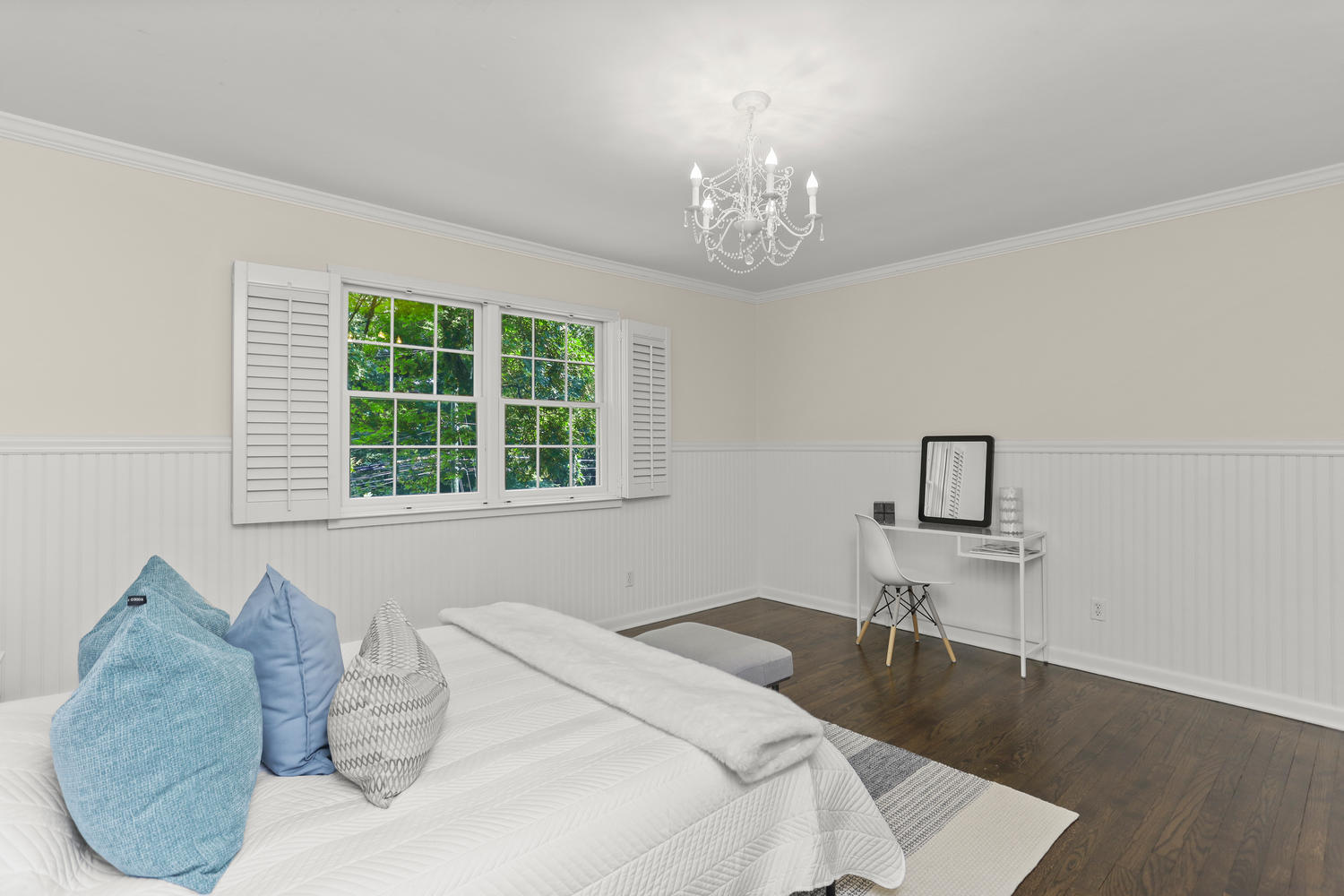 704 Valley Road New Canaan, CT 06840 - Photo 32 of 59 a bed sitting in a bedroom next to a window and a chandelier