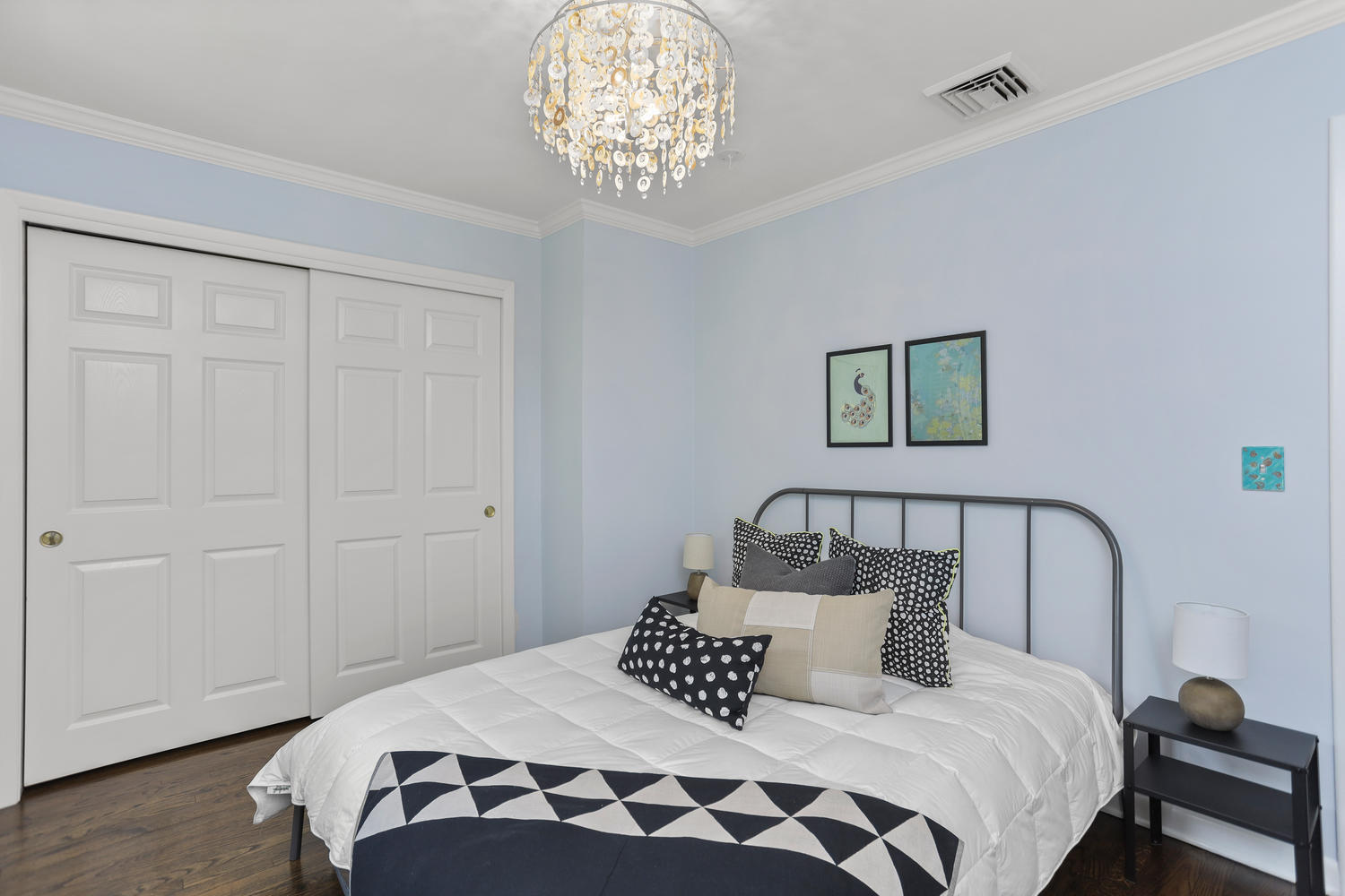 704 Valley Road New Canaan, CT 06840 - Photo 40 of 59 a bedroom with a large bed and a chandelier