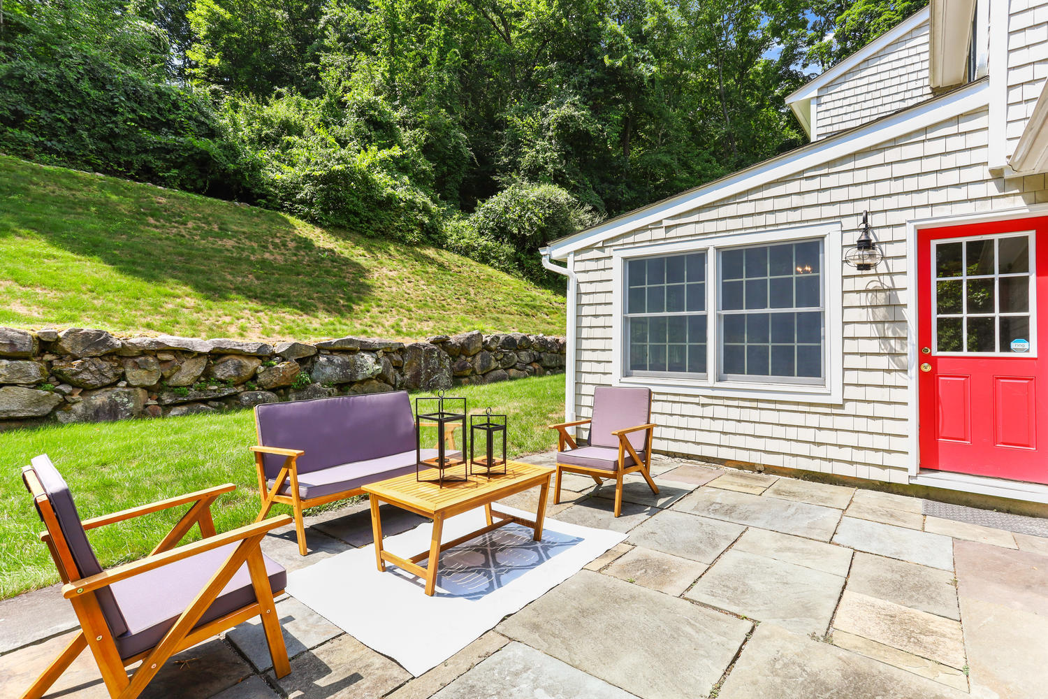 704 Valley Road New Canaan, CT 06840 - Photo 52 of 59 a backyard of a house with outdoor seating