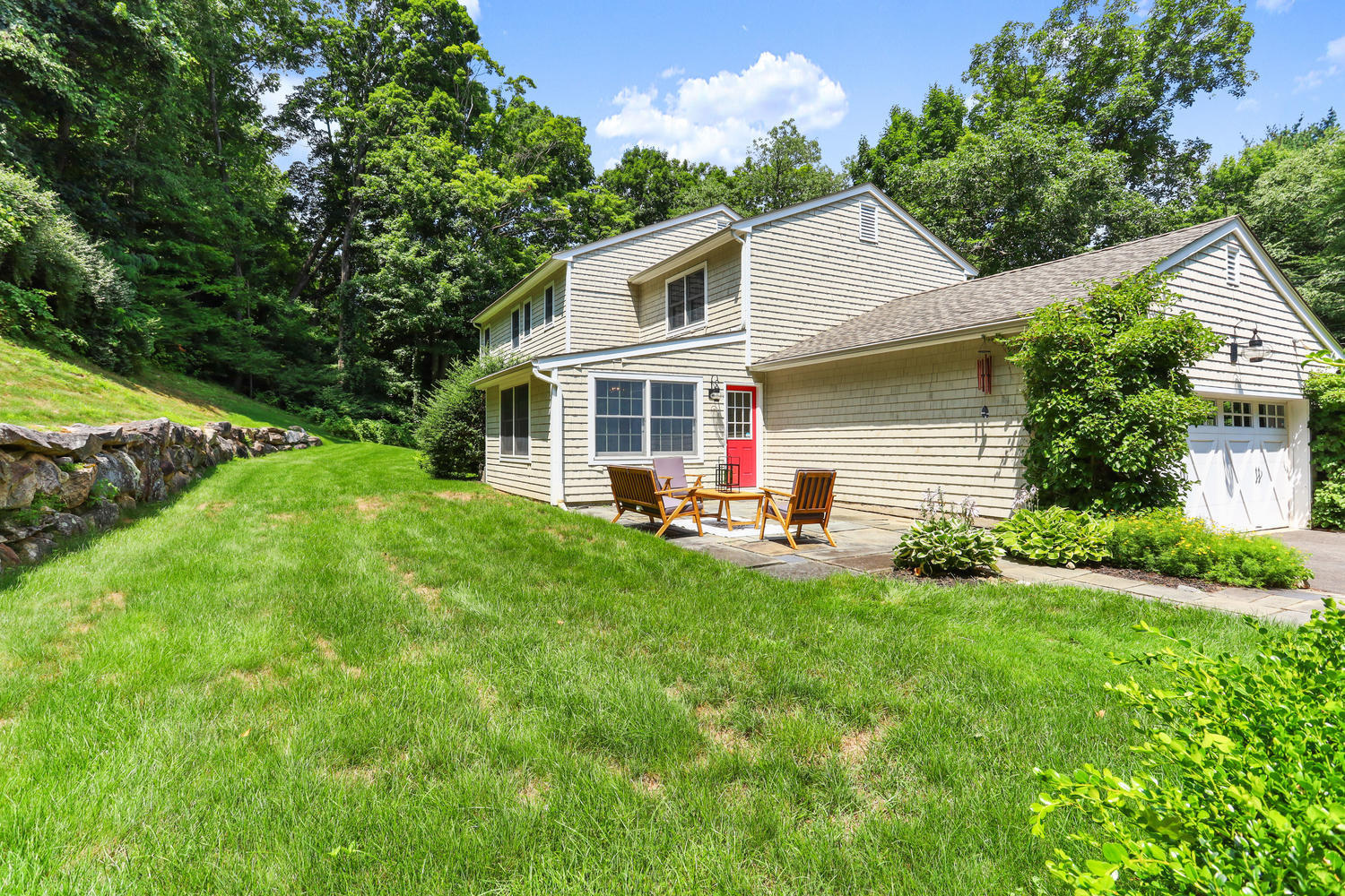 704 Valley Road New Canaan, CT 06840 - Photo 53 of 59 a view of a house with a yard and sitting area