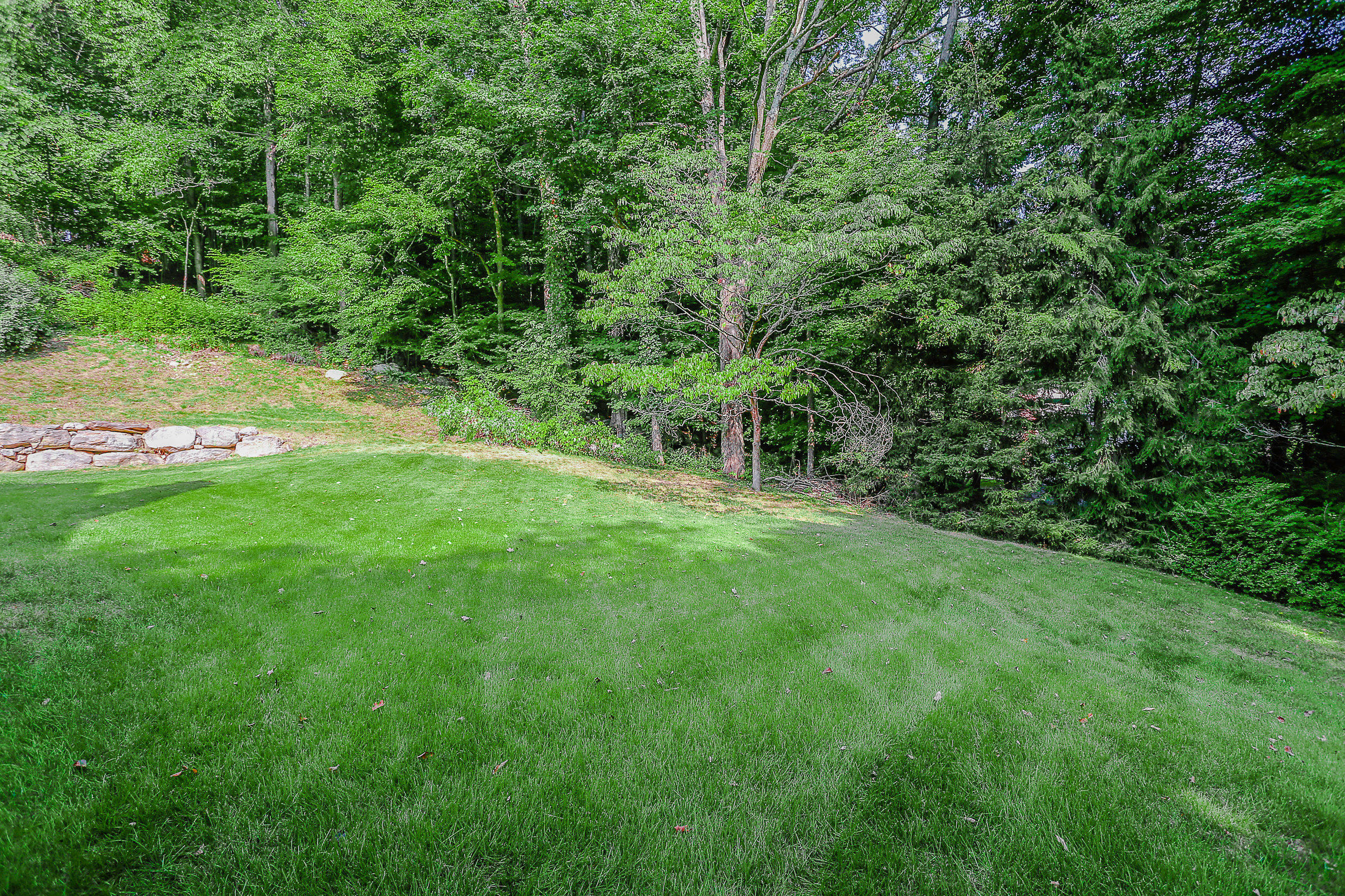704 Valley Road New Canaan, CT 06840 - Photo 55 of 59 a view of green field with trees in the background