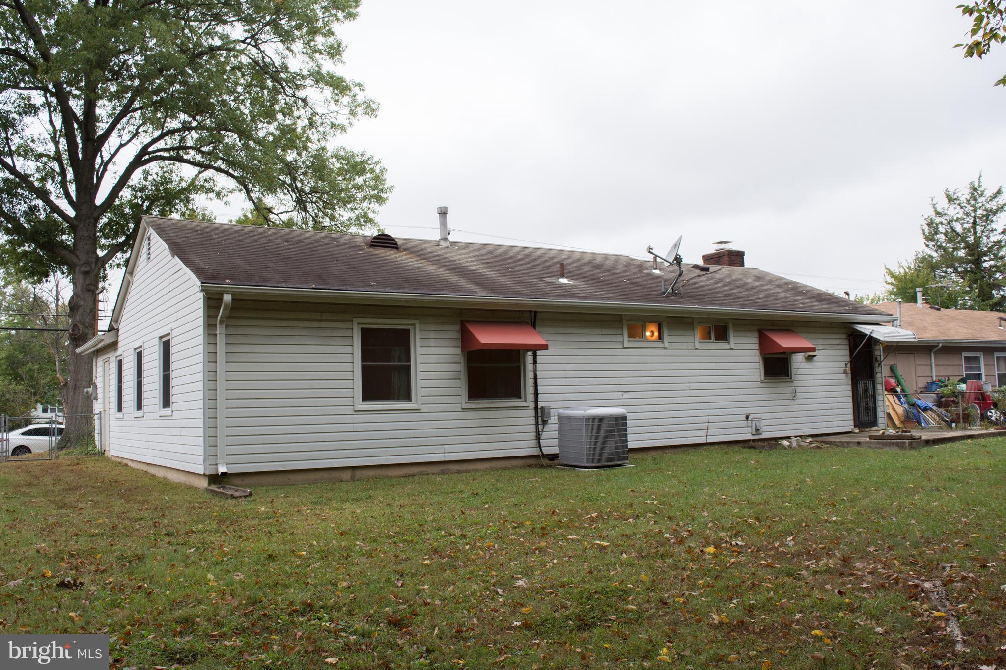 6217 Frontier Drive Springfield, VA 22150 - Photo 6 of 25 Exterior of house with a leveled backyard