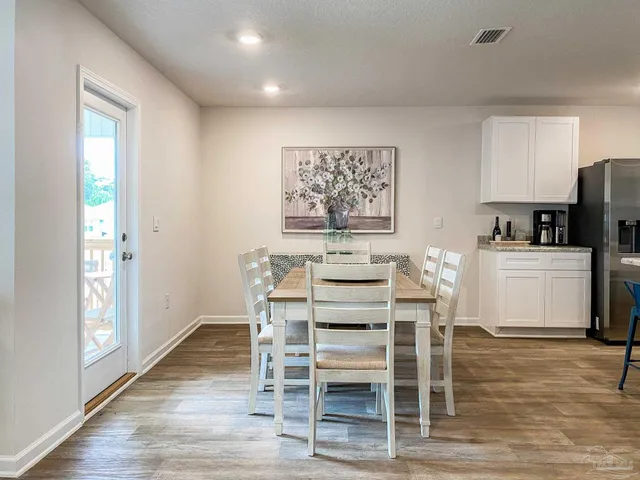 a view of a dining room with furniture and wooden floor