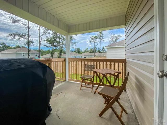 a view of a chairs and table in balcony