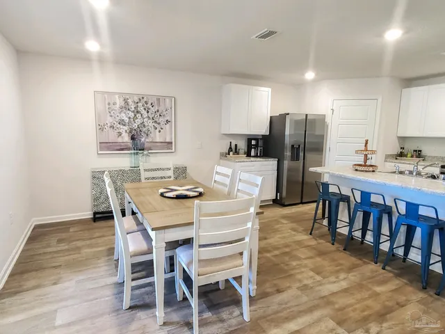 a large kitchen with a table and chairs in it