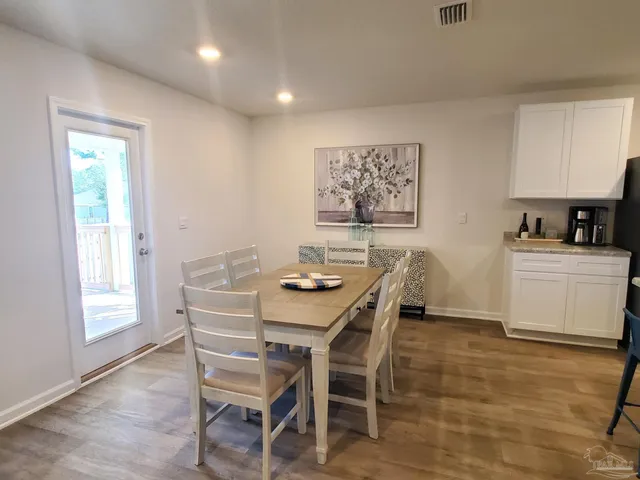 a view of a dining room with furniture and window