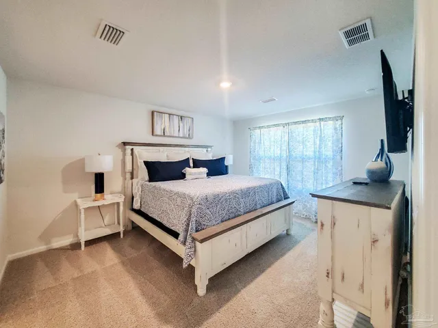 a bedroom with a bed and window