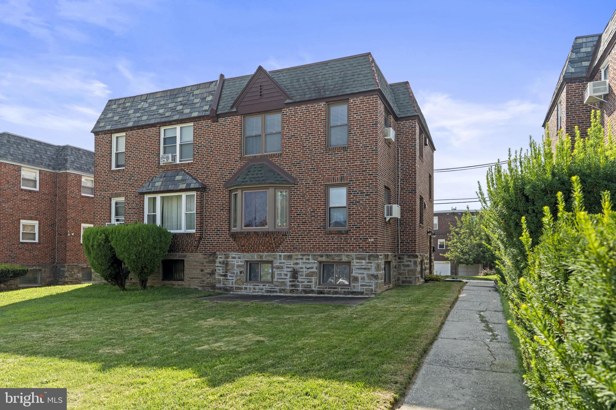 936 Vernon Road, Unit 2 Philadelphia, PA 19150 - Photo 1 of 19 a front view of a house with a garden