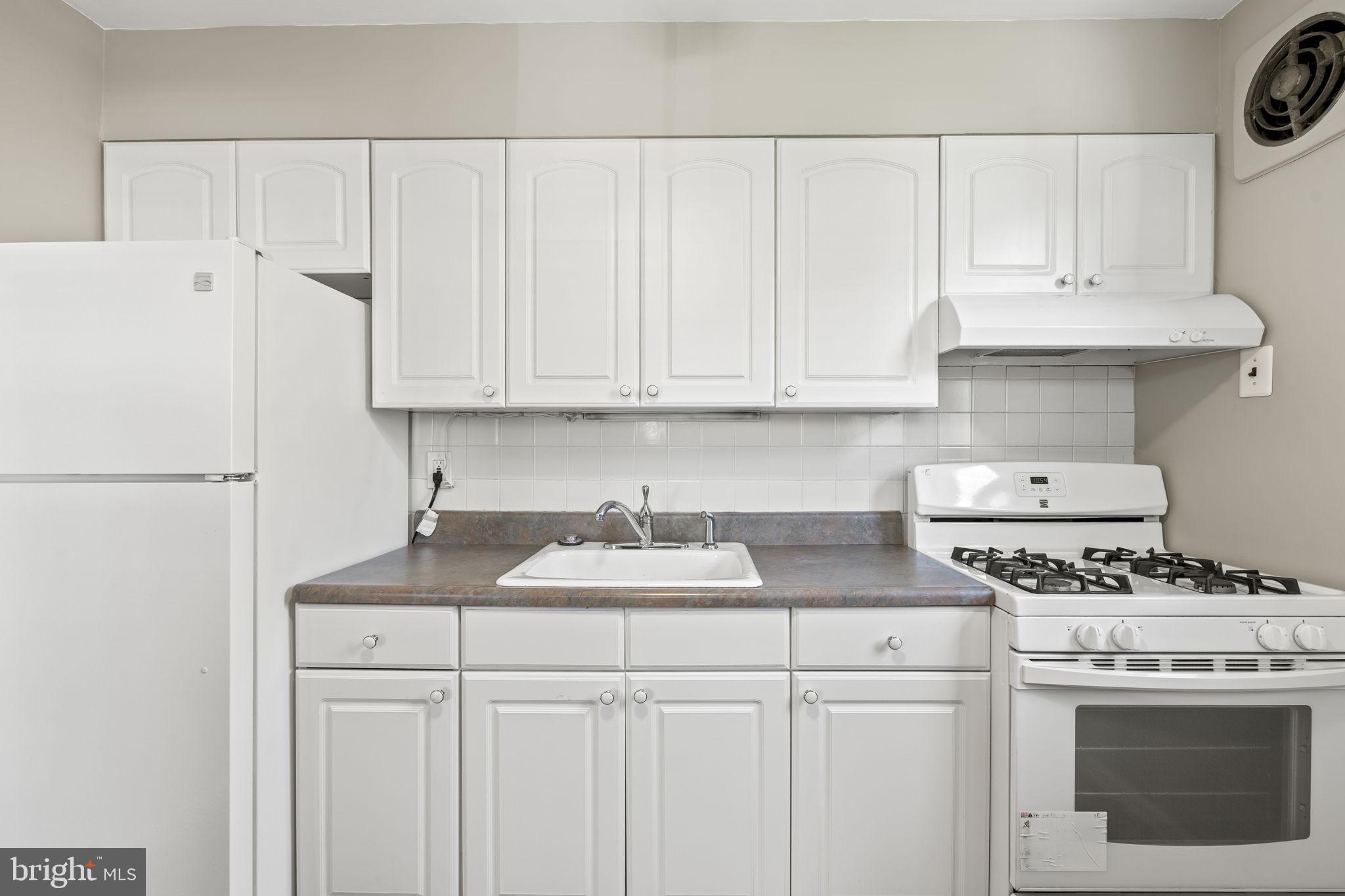 936 Vernon Road, Unit 2 Philadelphia, PA 19150 - Photo 11 of 19 a kitchen with stainless steel appliances granite countertop a sink stove and refrigerator