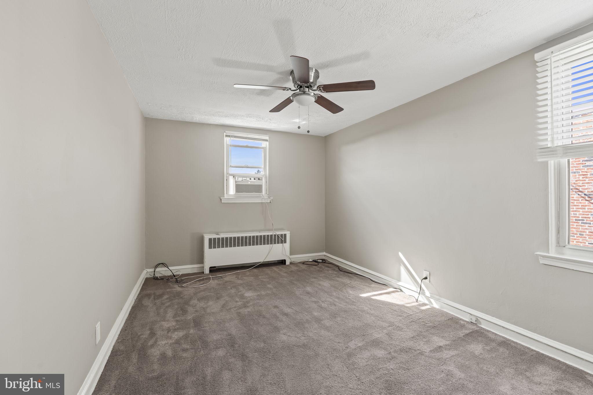 936 Vernon Road, Unit 2 Philadelphia, PA 19150 - Photo 13 of 19 an empty room with windows and fan