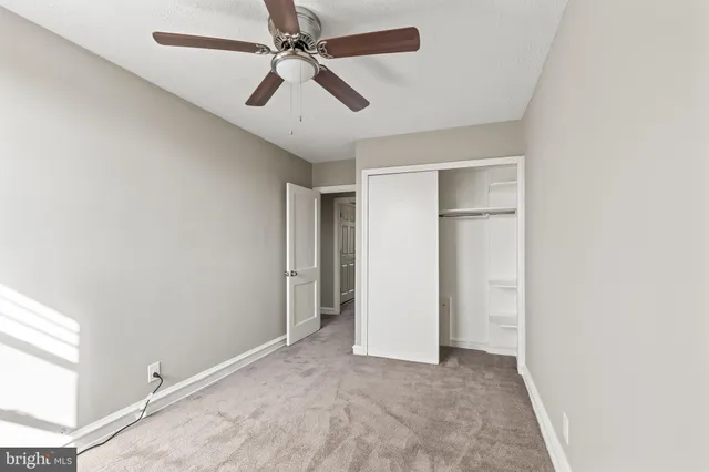 a view of a livingroom with a ceiling fan and window