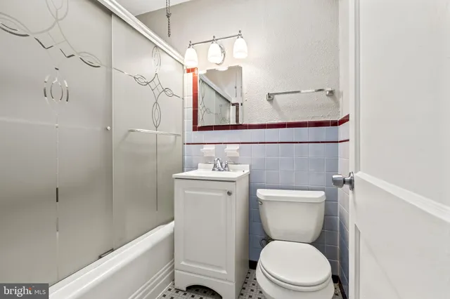 a bathroom with a toilet a sink and bathtub