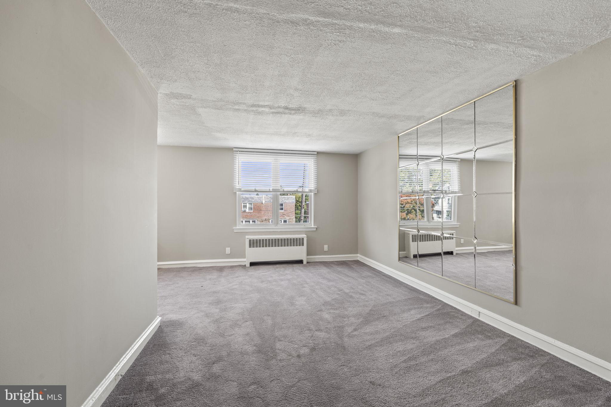 936 Vernon Road, Unit 2 Philadelphia, PA 19150 - Photo 5 of 19 a view of an empty room with a window