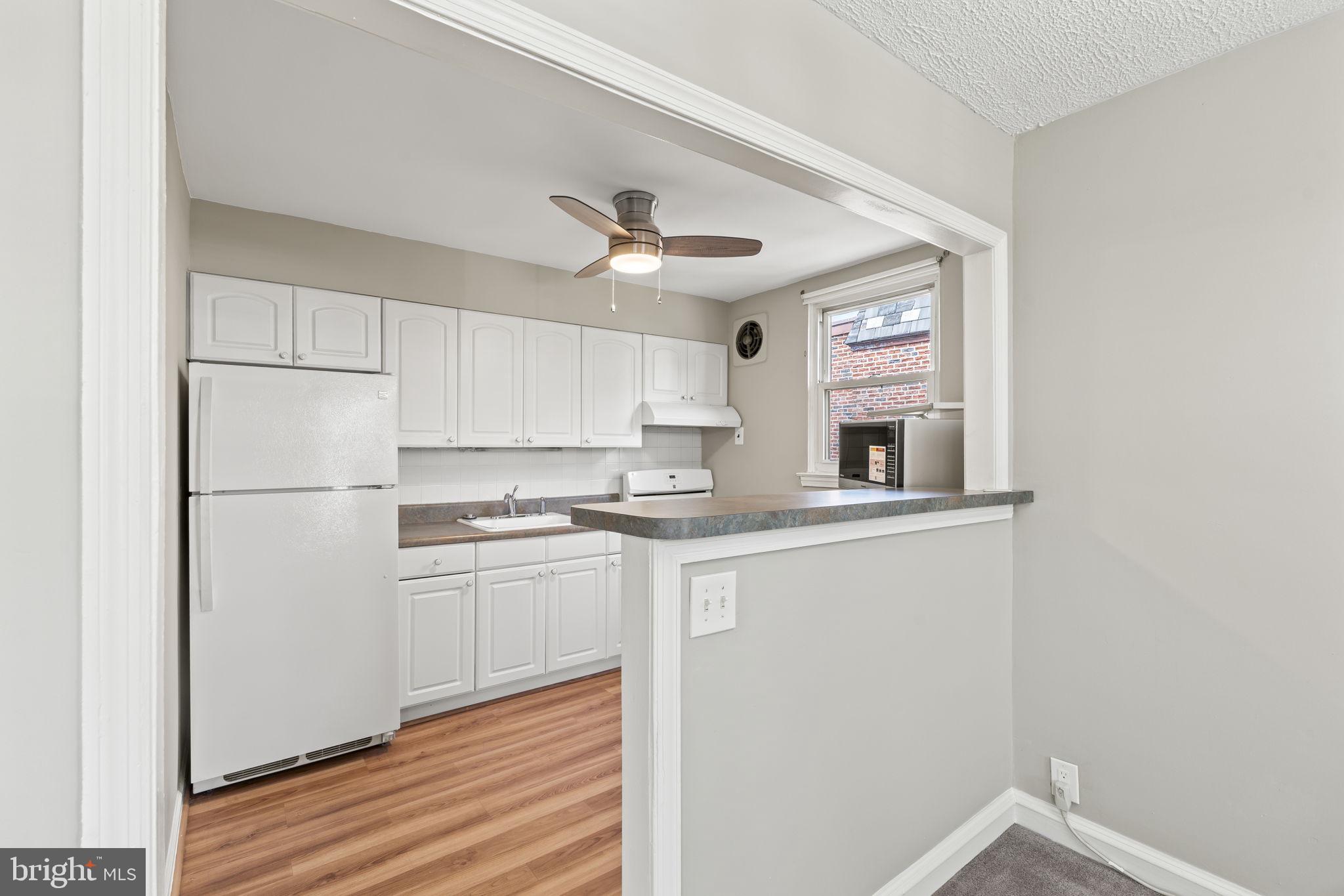 936 Vernon Road, Unit 2 Philadelphia, PA 19150 - Photo 9 of 19 a kitchen with stainless steel appliances granite countertop a sink a stove and a refrigerator