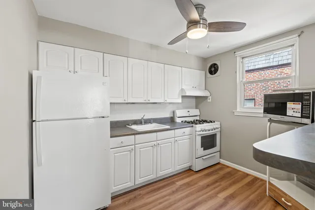 a kitchen with stainless steel appliances a refrigerator sink and cabinets