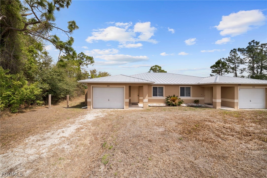 4838 29th Street Southwest Lehigh Acres, FL 33973 - Photo 1 of 25 a view of a house with a yard and sitting area