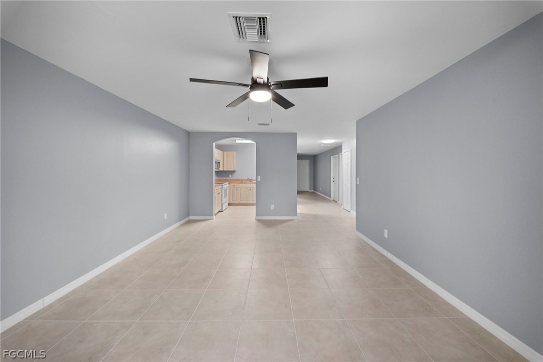 4838 29th Street Southwest Lehigh Acres, FL 33973 - Photo 16 of 25 a view of a big room with a ceiling fan and chandelier fan
