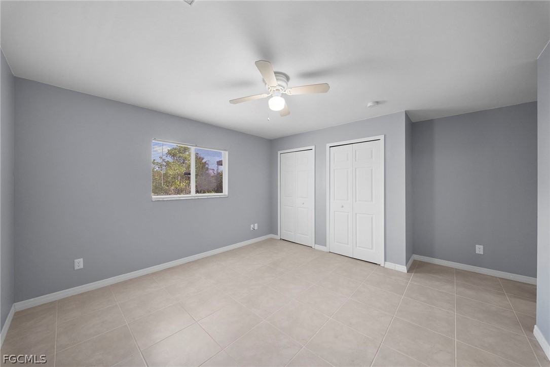 4838 29th Street Southwest Lehigh Acres, FL 33973 - Photo 18 of 25 an empty room with a ceiling fan and a window