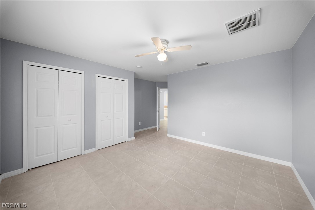 4838 29th Street Southwest Lehigh Acres, FL 33973 - Photo 19 of 25 an empty room with a ceiling fan and a window