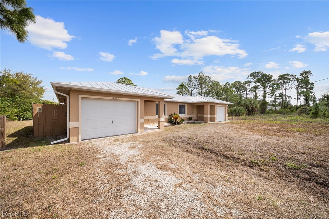 4838 29th Street Southwest Lehigh Acres, FL 33973 - Photo 2 of 25 a front view of a house with a yard and garage