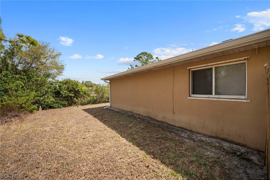 4838 29th Street Southwest Lehigh Acres, FL 33973 - Photo 22 of 25 a backyard of a house with lots of green space